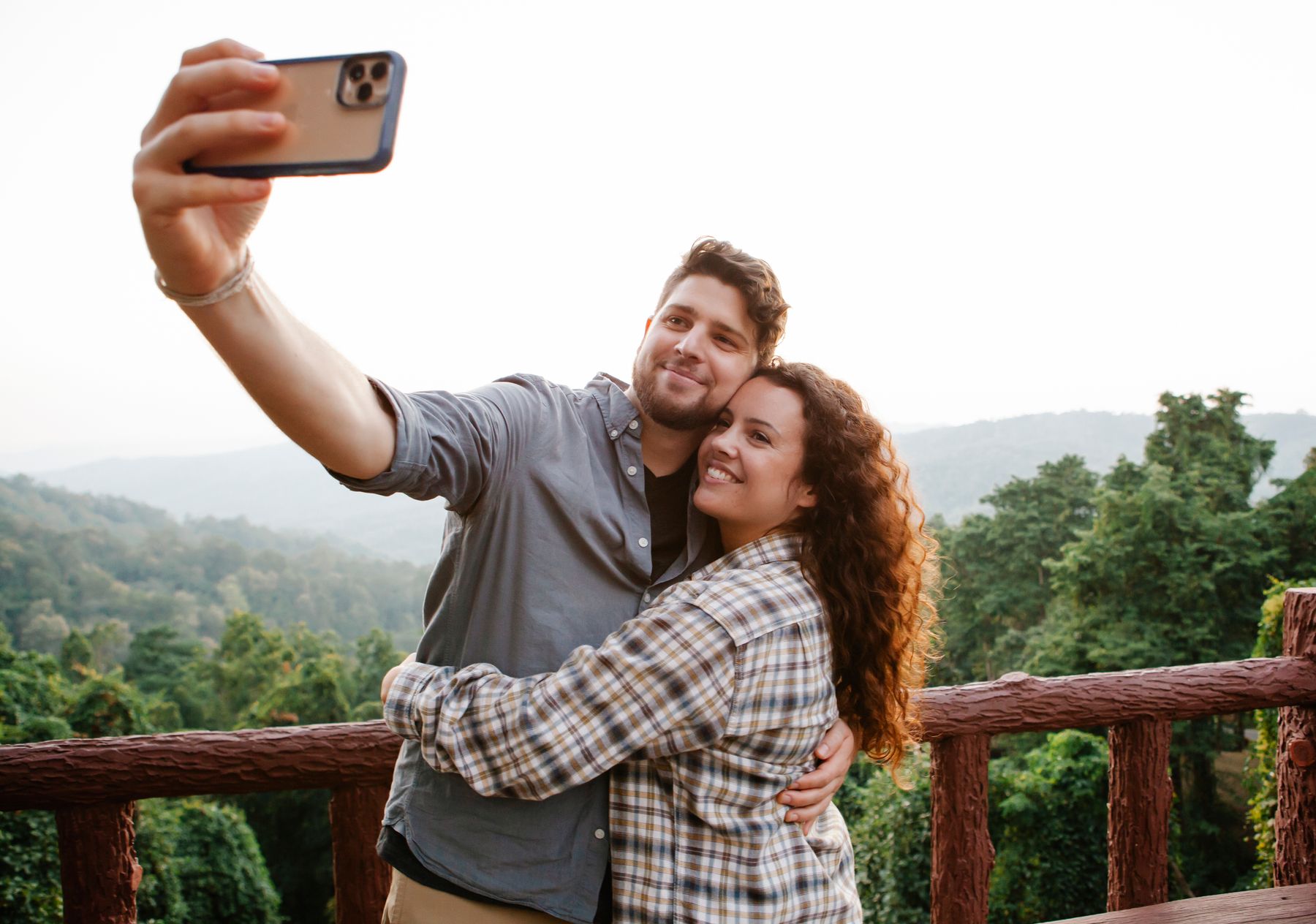 A happy couple taking a selfie on a trip