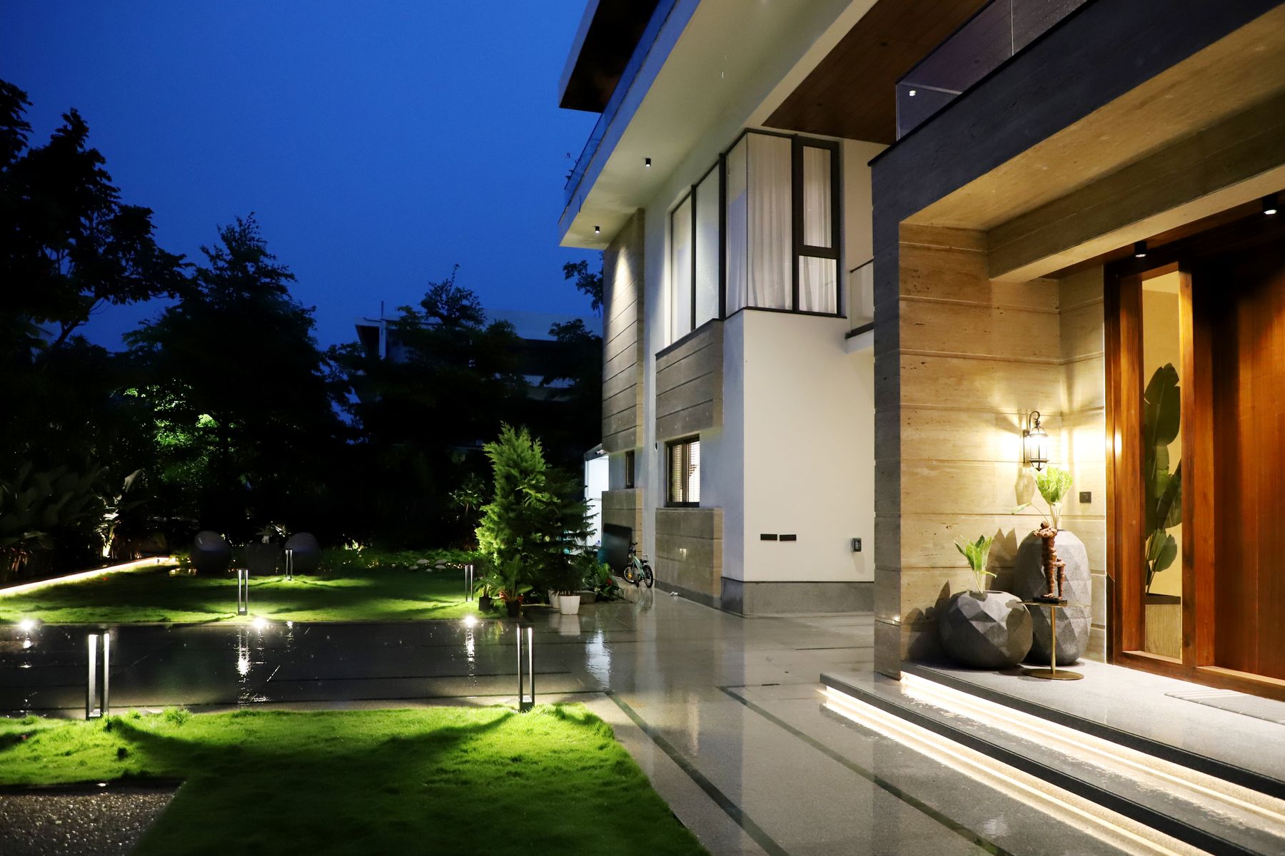 A modern residence lit at night