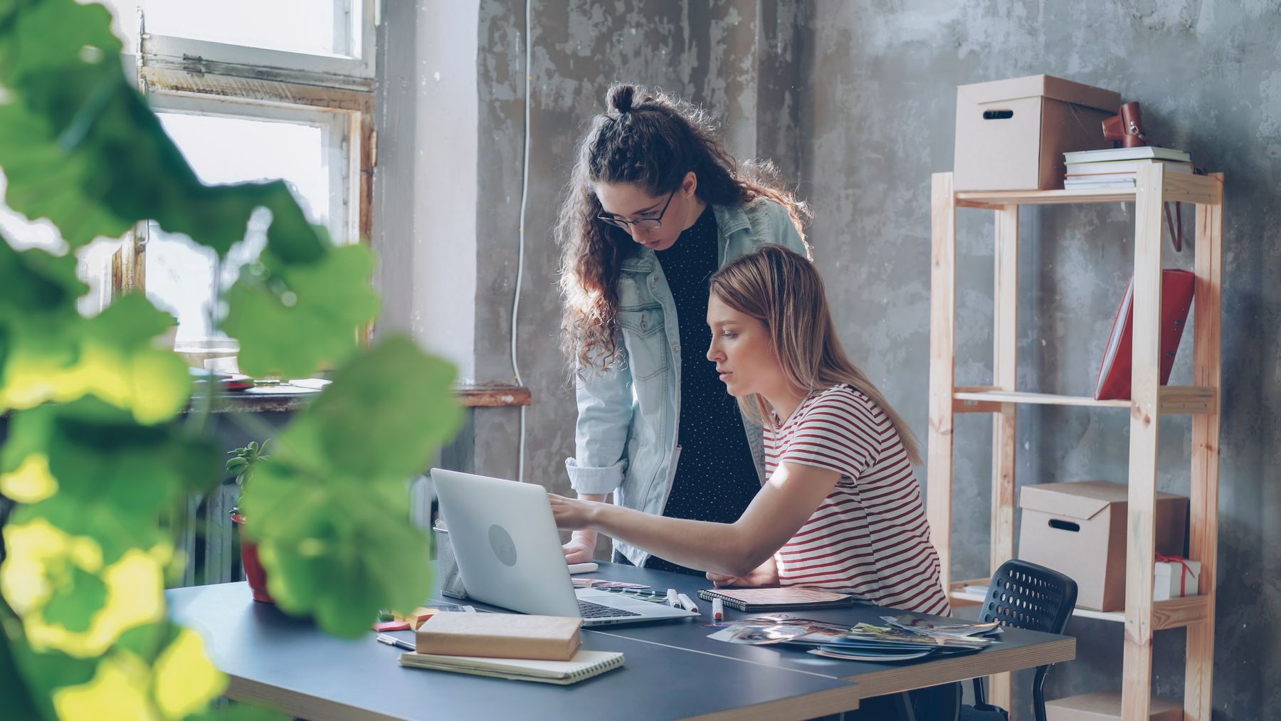 Two colleagues working at a laptop