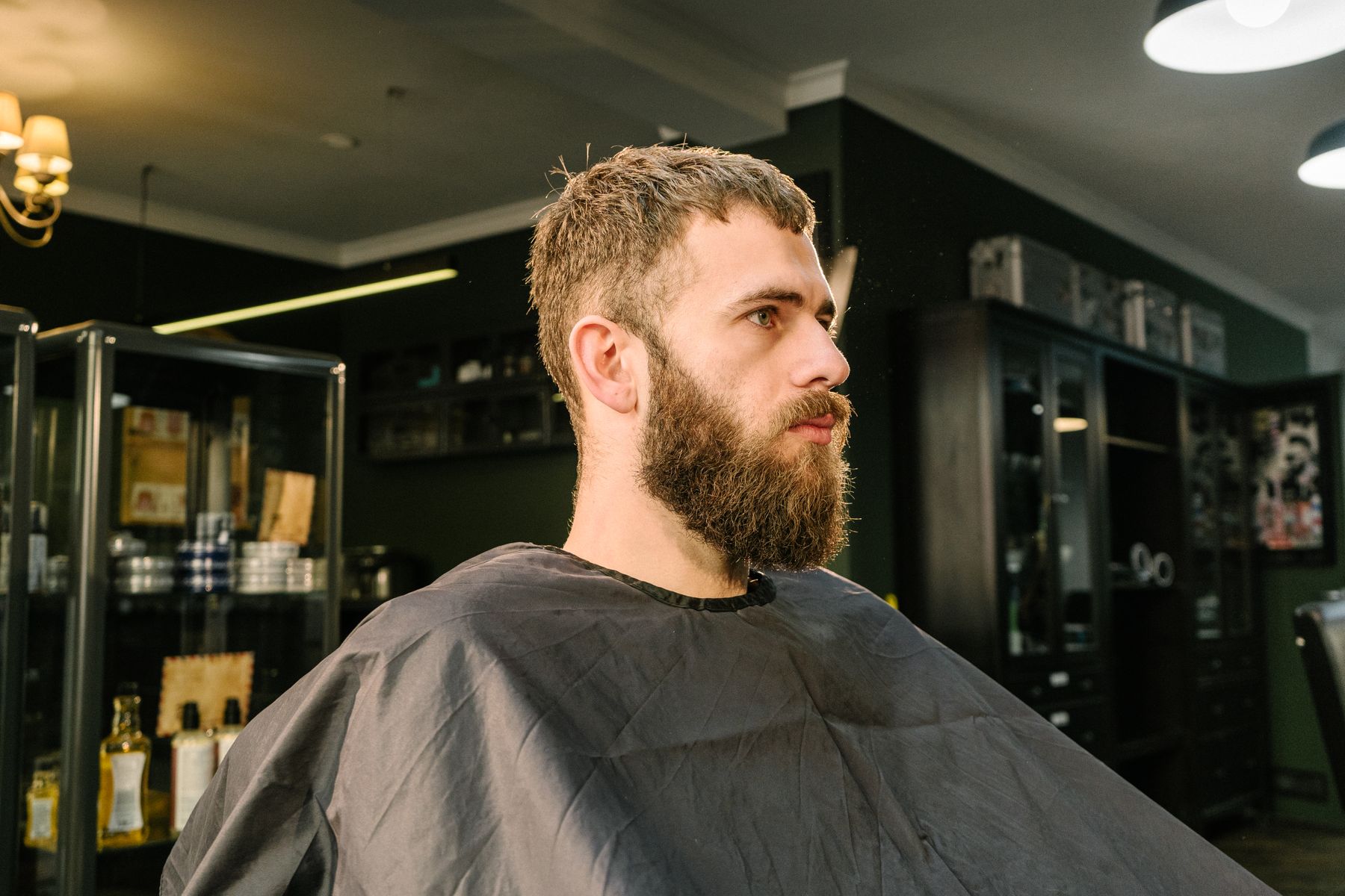 A client with a full beard in the barber chair