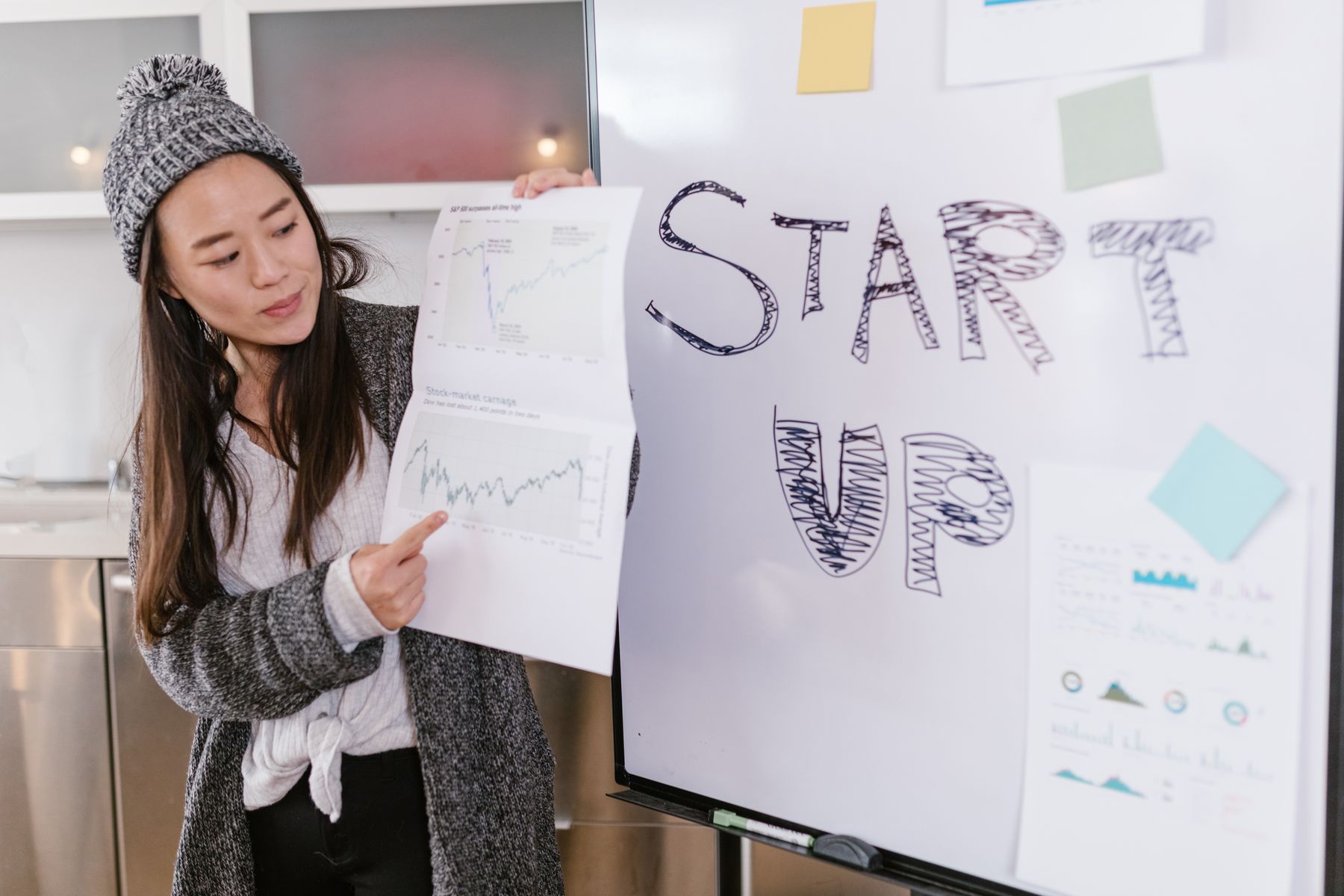 A presenter pointing at growth charts