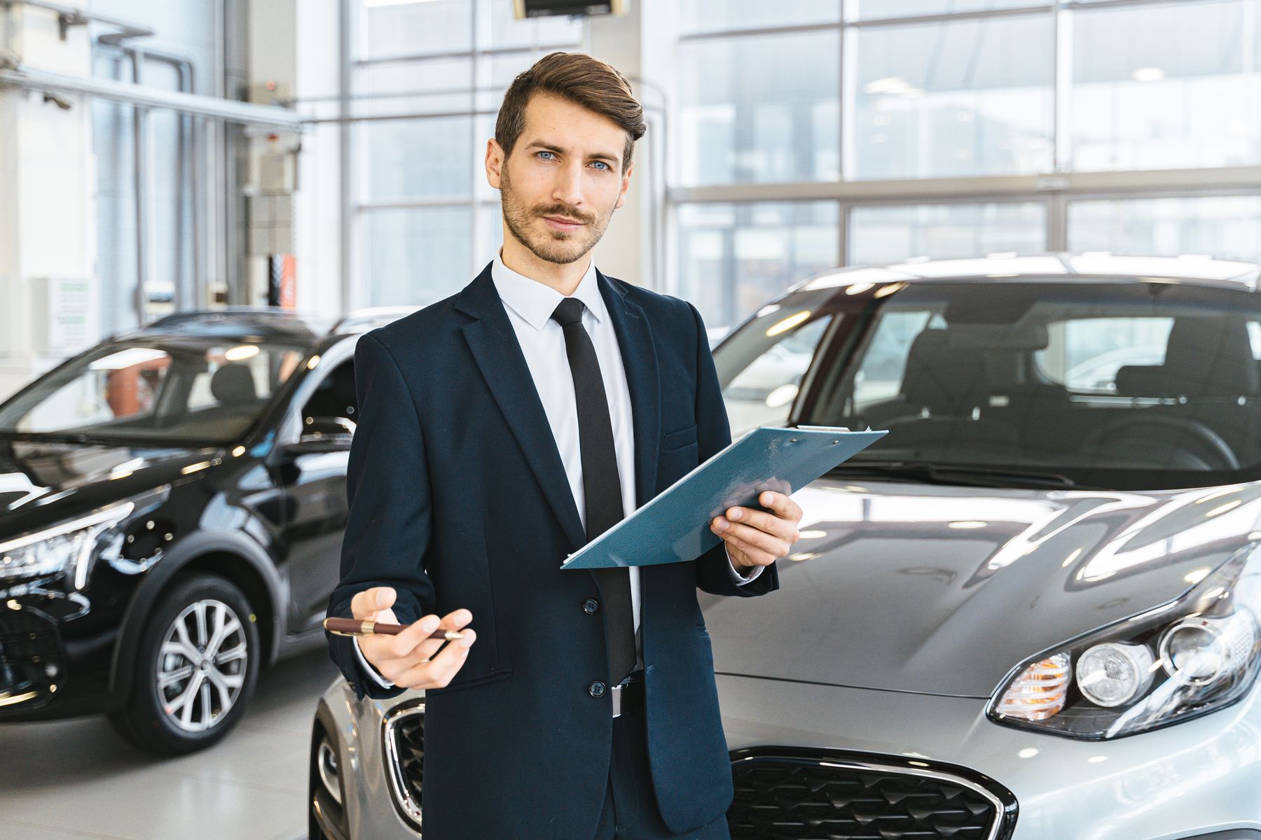 A dealer standing in a showroom