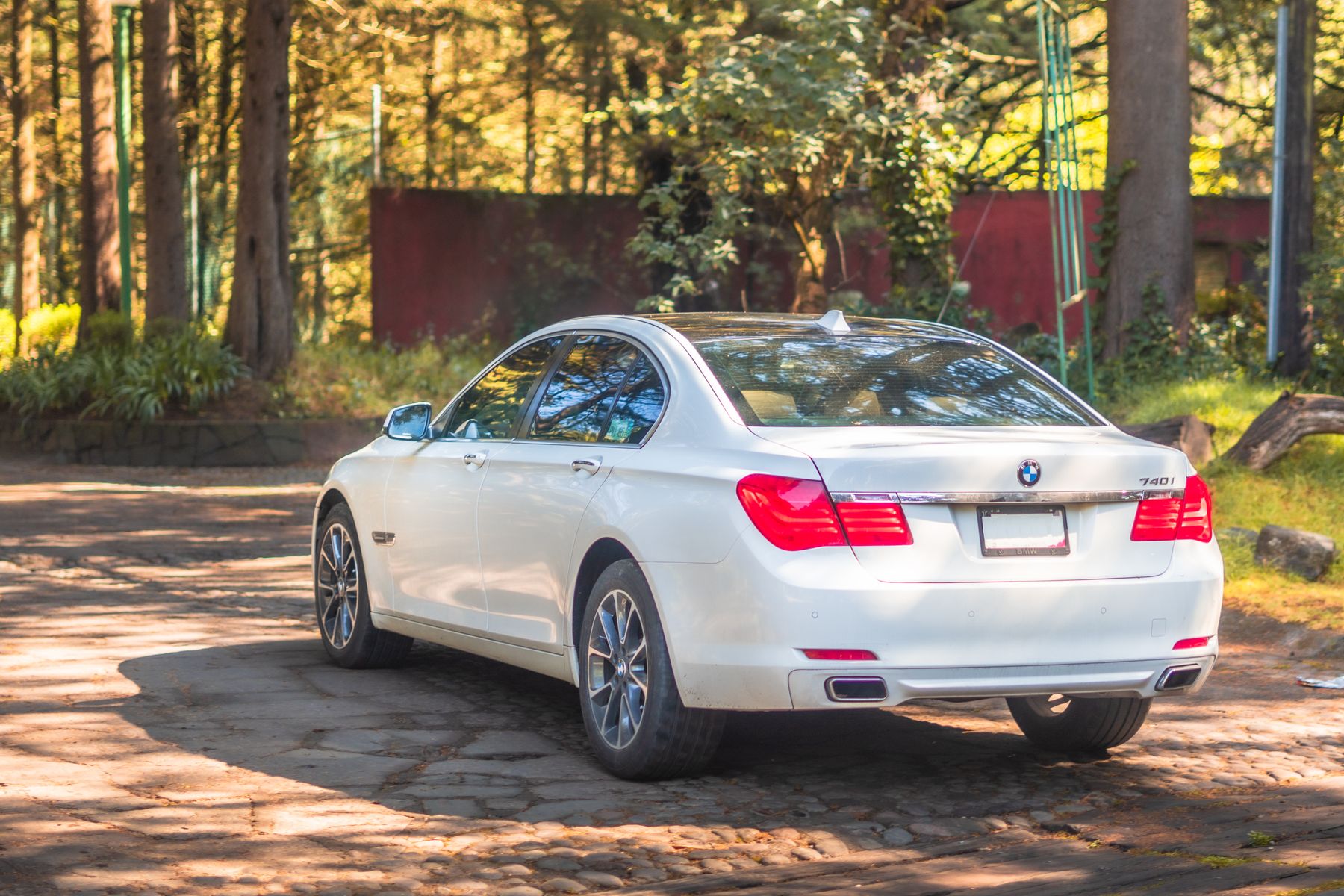 A white sedan on a forest road