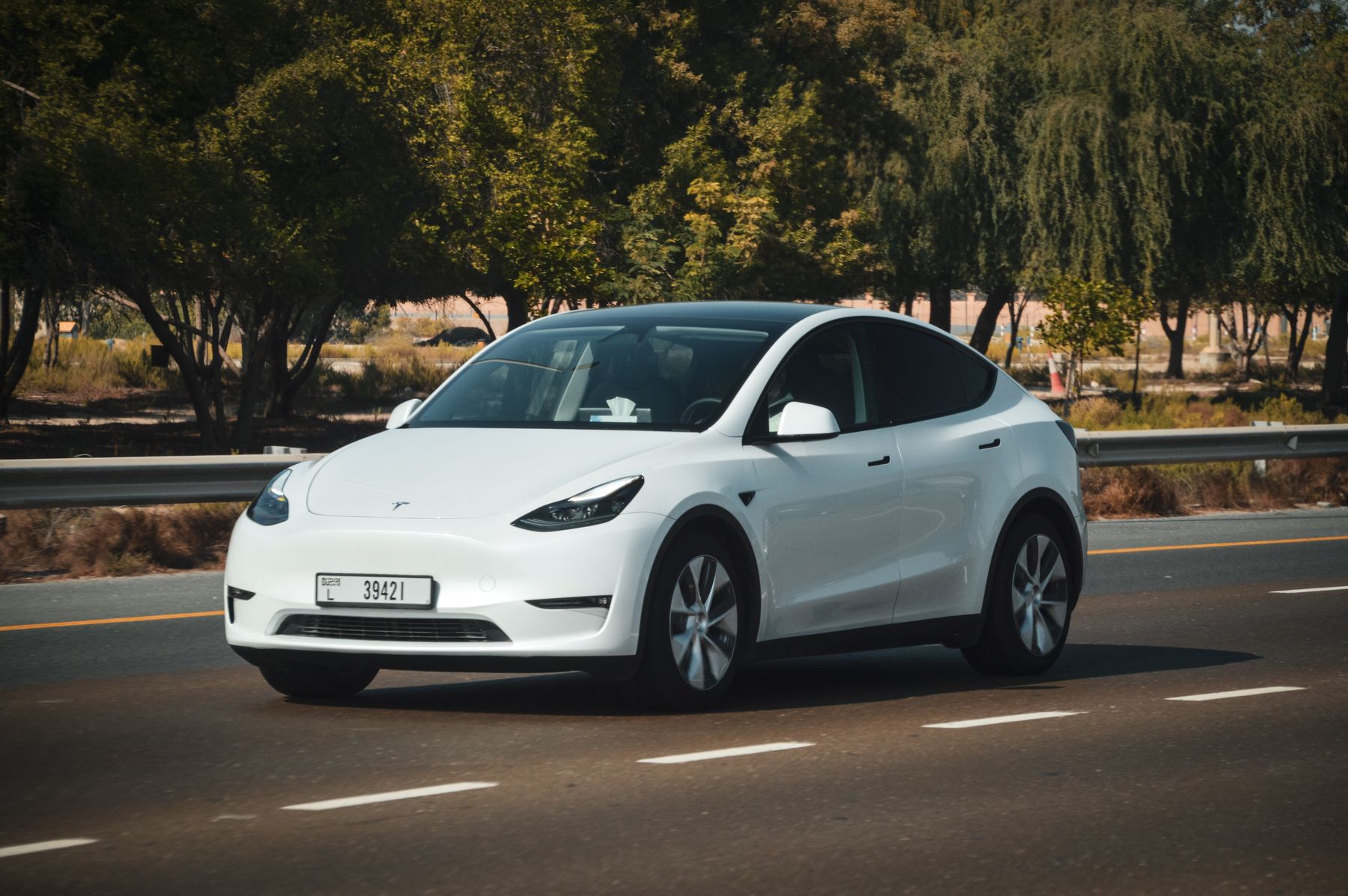 A white electric SUV on a sunny road
