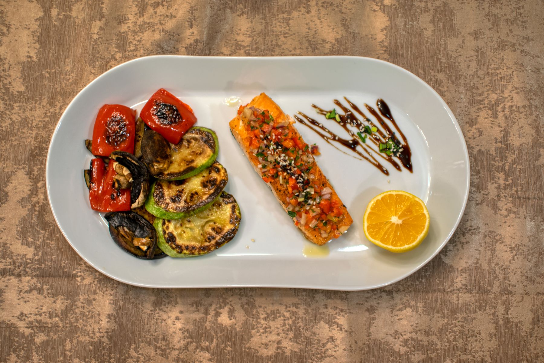 Grilled vegetables and salmon on a platter