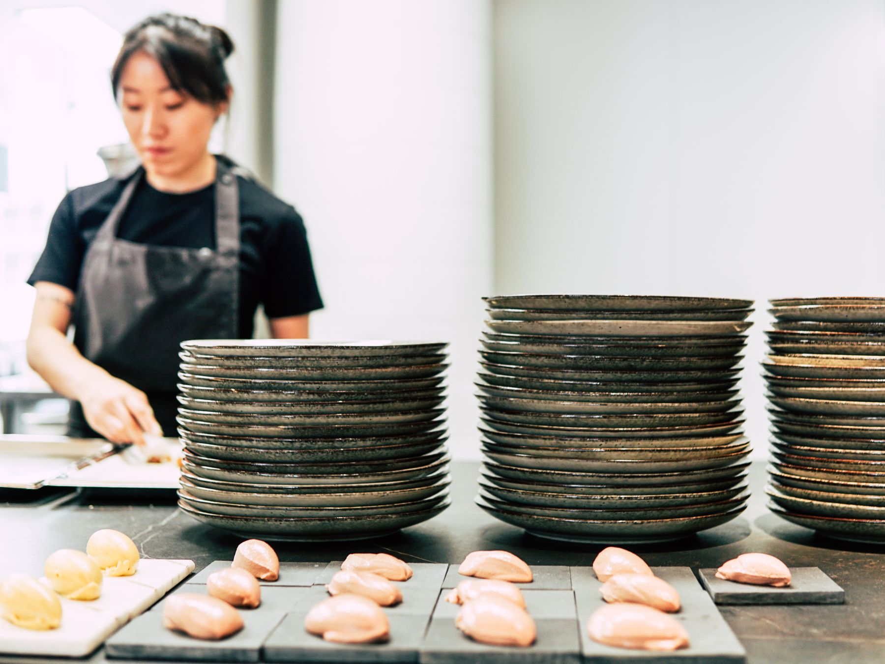 Chefs preparing plates in a kitchen