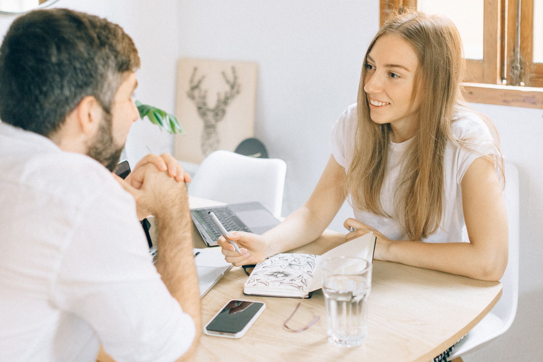 A coach and client talking at a table