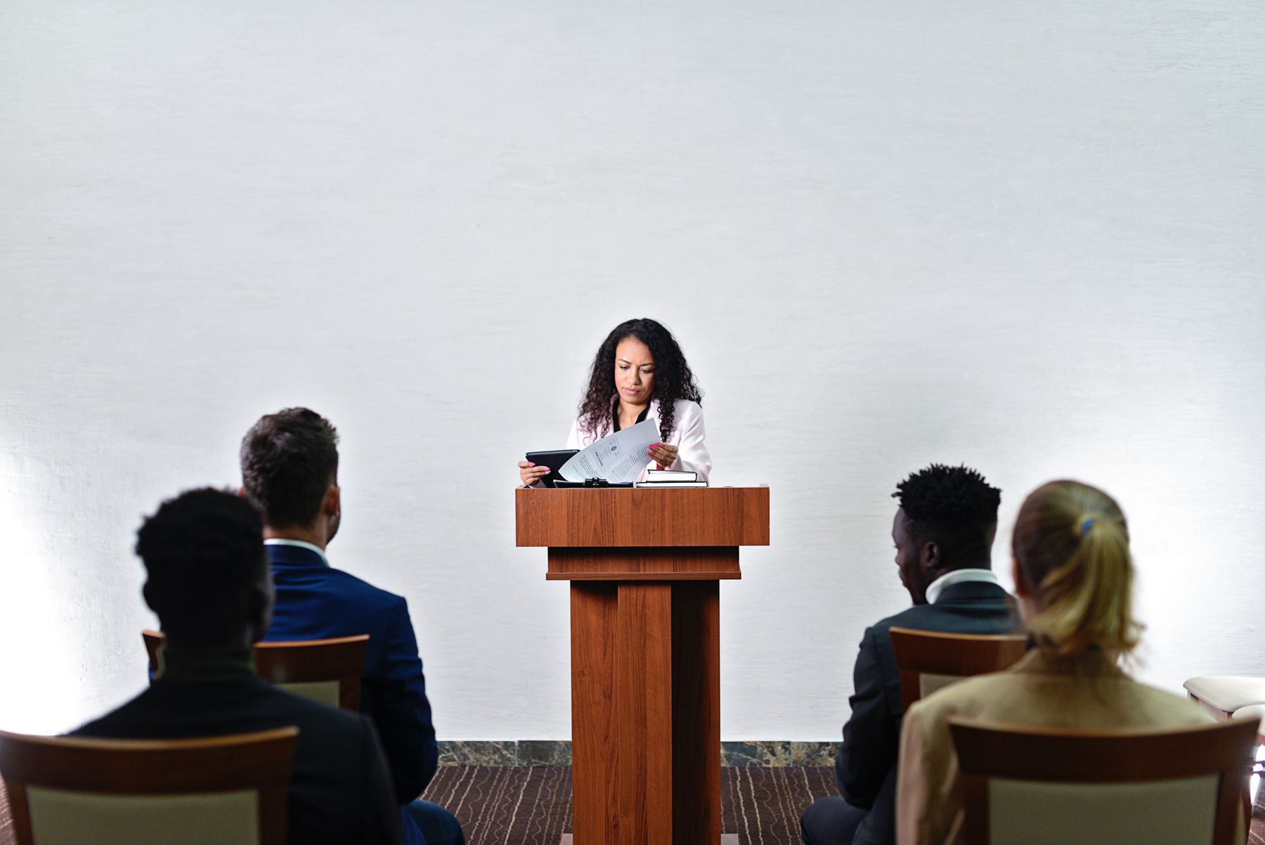 A speaker at a podium addressing an audience