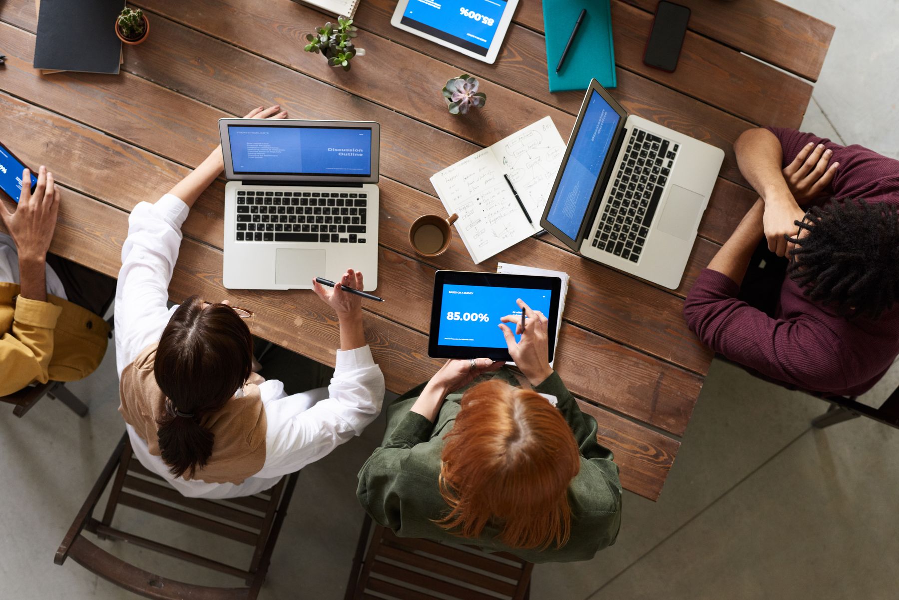 A team working on laptops around a table