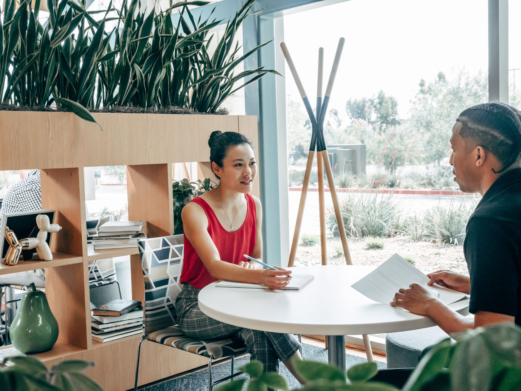 Two people talking at a round table