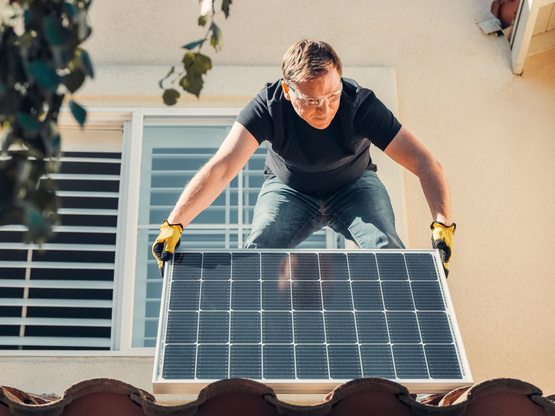 An installer carrying a solar panel