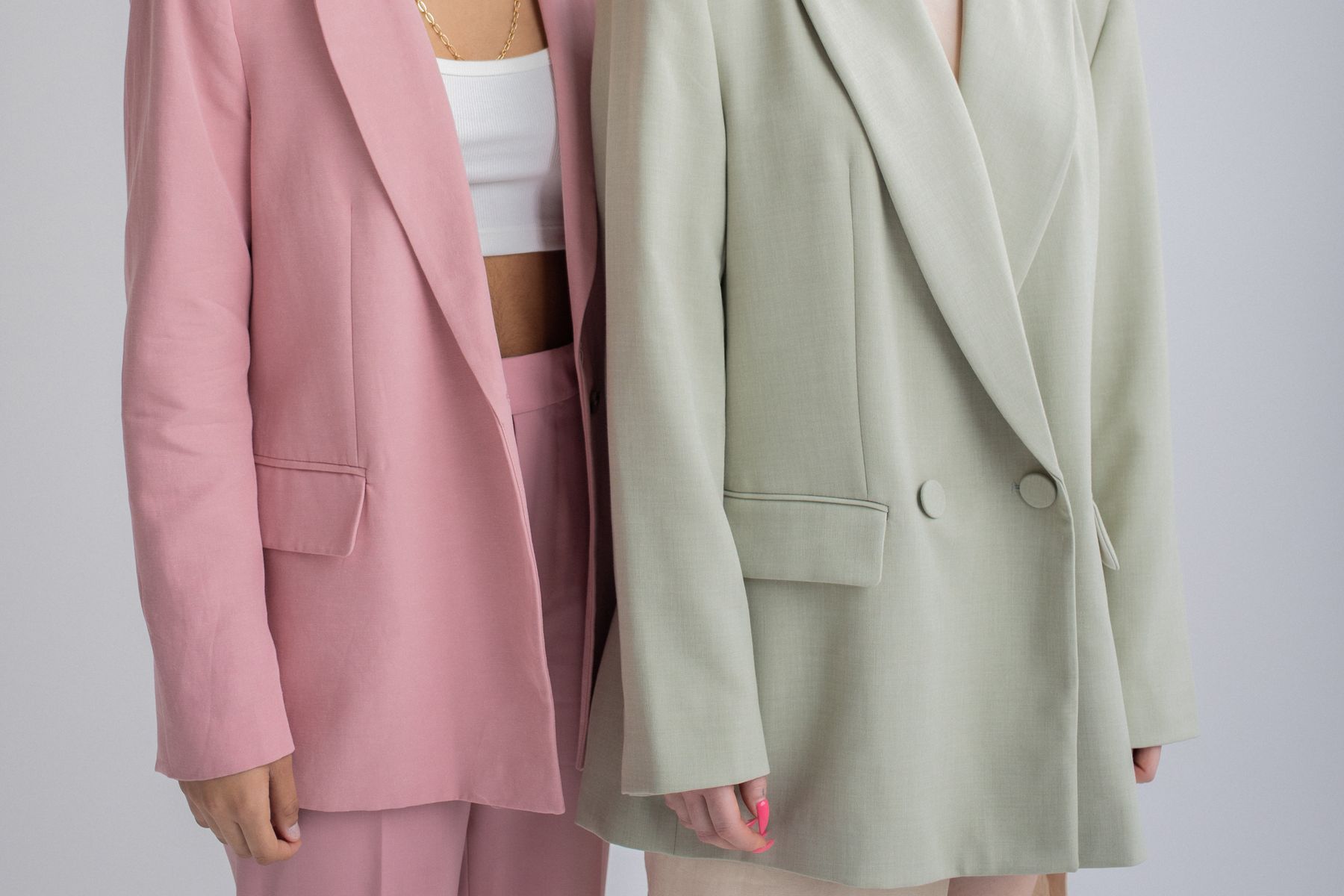 The buttons and tailoring of two pastel blazers