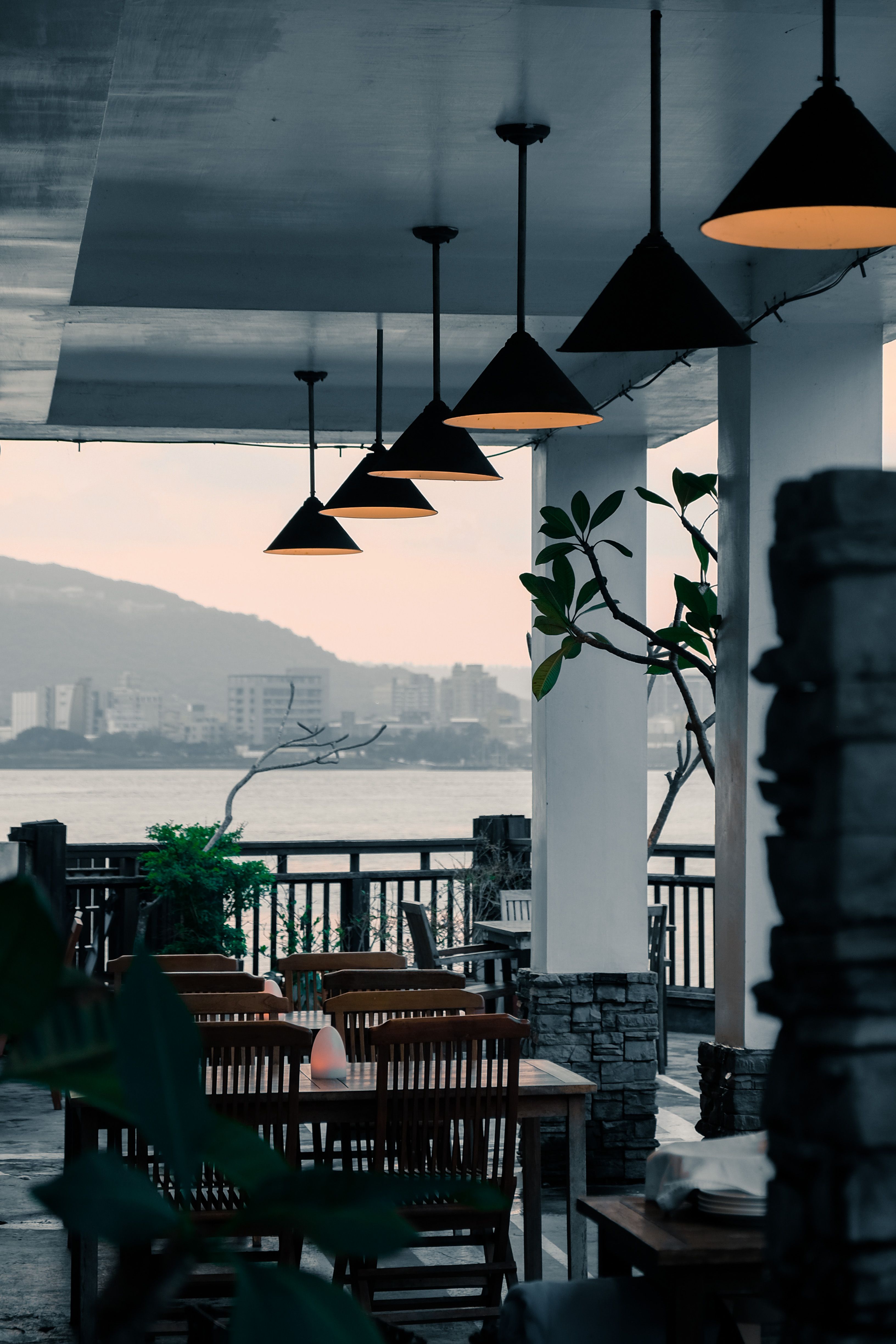 An inviting restaurant terrace overlooking the sea at dusk