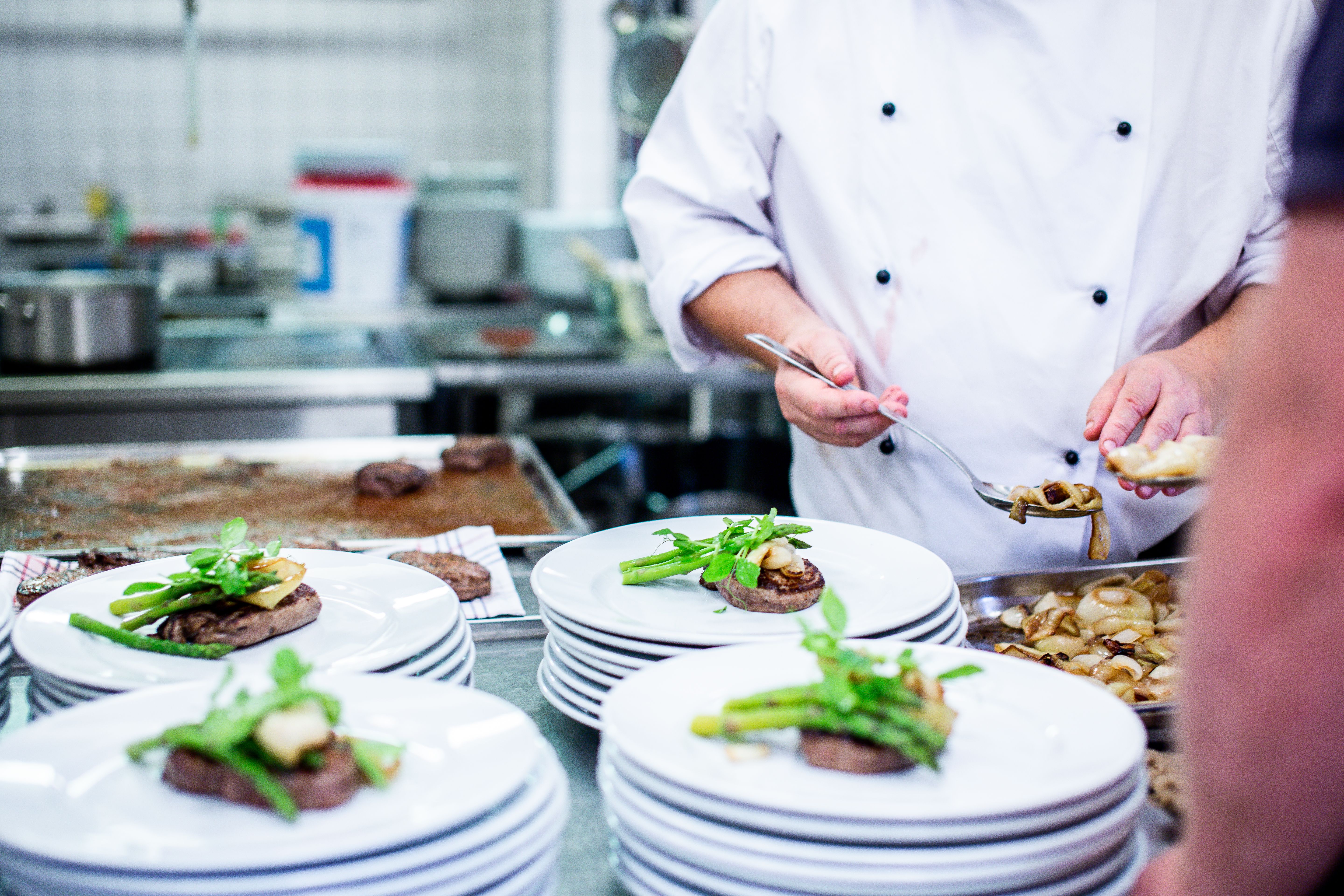 A chef finishing a dish